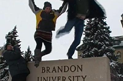 #ETMOOC contribution screenshot, Mike Nantais on microphone singing, Kirsten Thompson and Tyler Letkgram jumping off Brandon University Sign